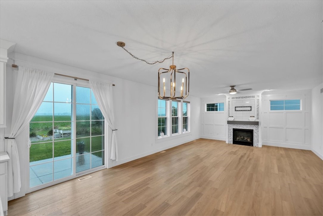 908 Declaration Drive Savoy, IL 61874 - Photo 20 of 41 a view of a livingroom with a fireplace wooden floor and windows