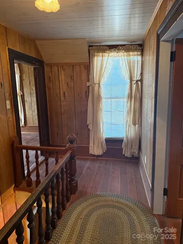 a view of a room with wooden floor and windows