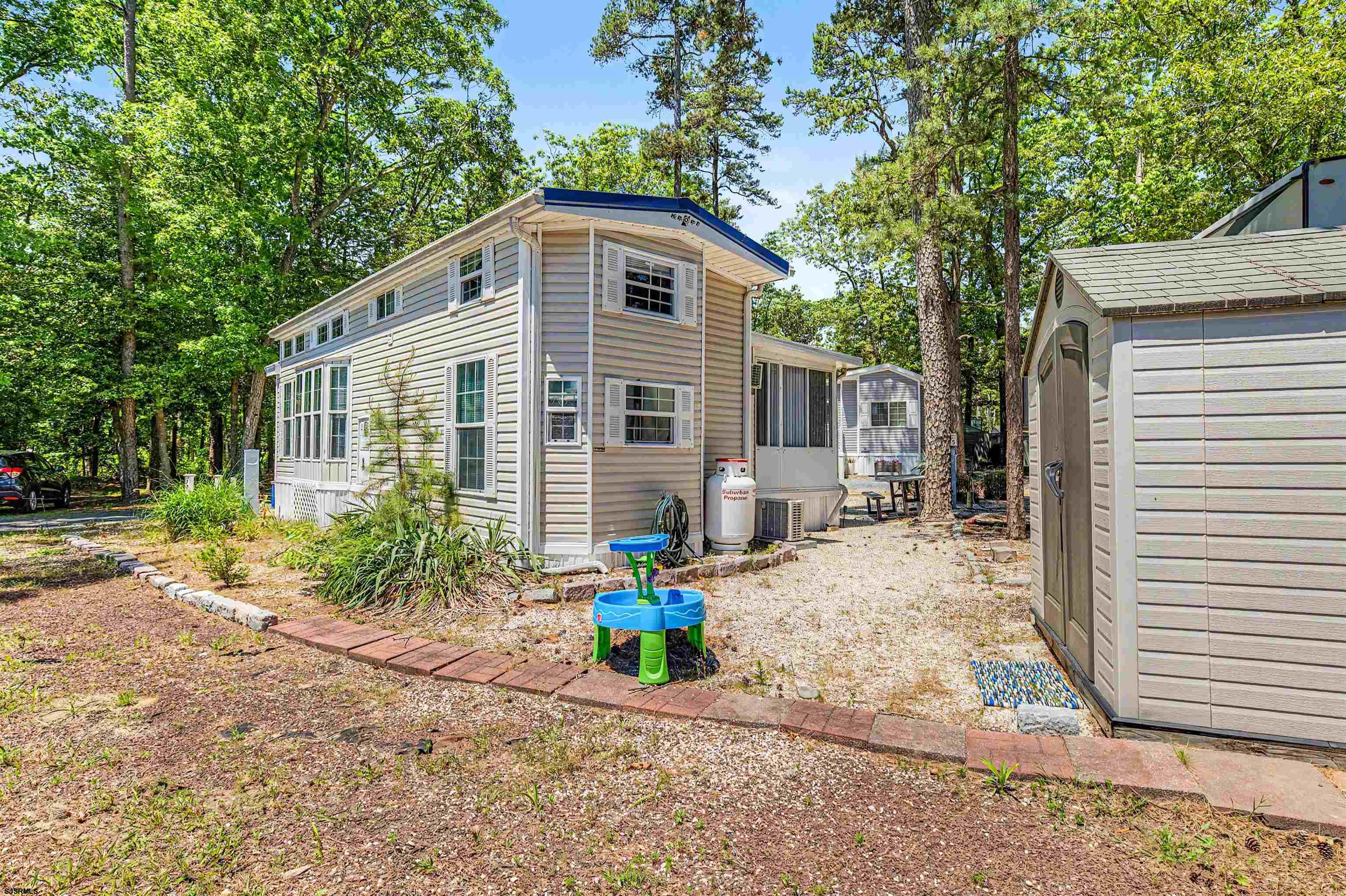 3066 Route 9 Ocean View, NJ 08230 - Photo 23 of 29 a front view of a house with a yard and potted plants