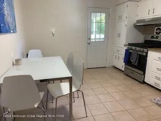 a kitchen with a table chairs and a stove