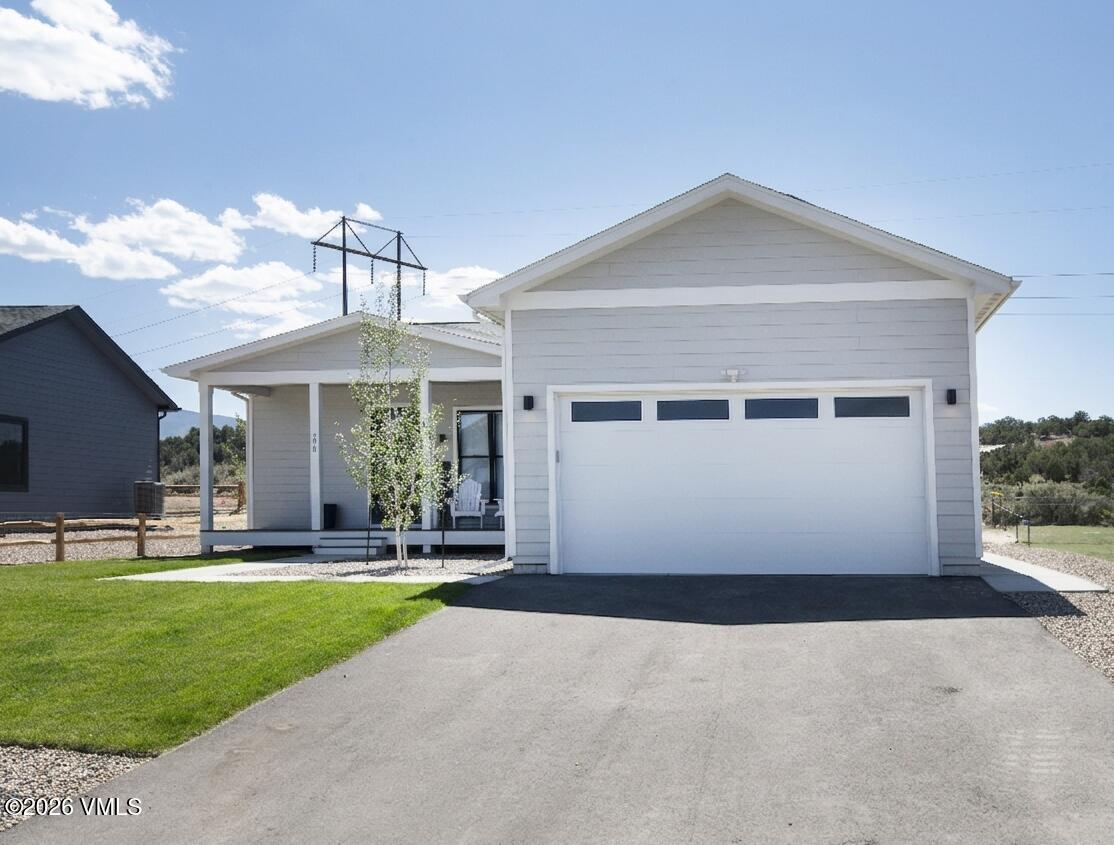 270 Blackhawk Road Gypsum, CO 81637 - Photo 1 of 27 a front view of a house with a yard and garage