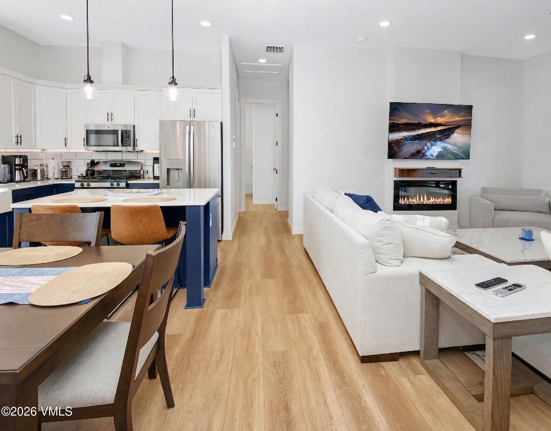 270 Blackhawk Road Gypsum, CO 81637 - Photo 13 of 27 a kitchen with stainless steel appliances kitchen island granite countertop a table chairs and a refrigerator