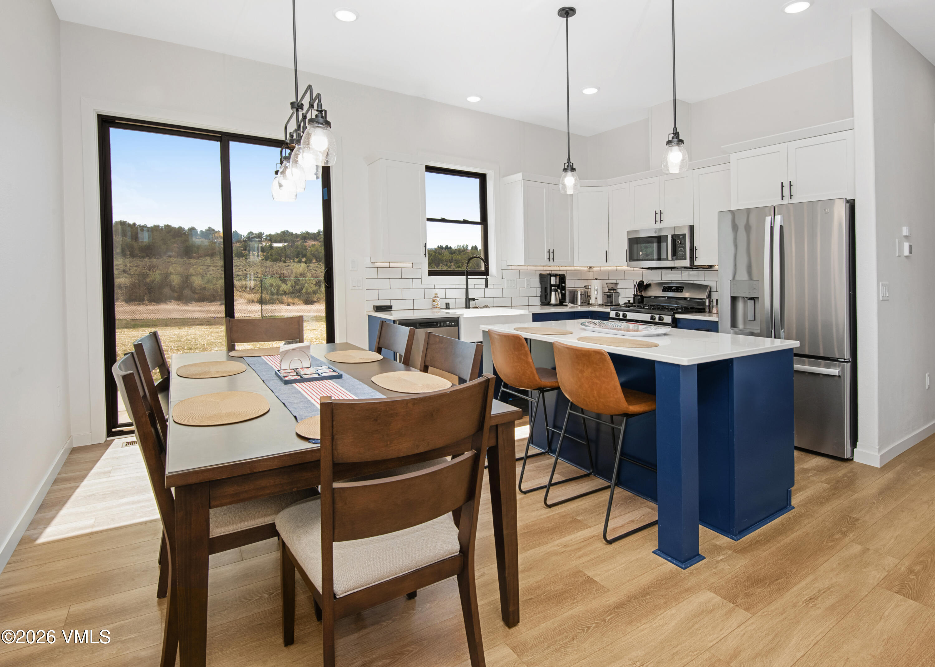 270 Blackhawk Road Gypsum, CO 81637 - Photo 5 of 27 a dining room with stainless steel appliances granite countertop a table chairs refrigerator and sink