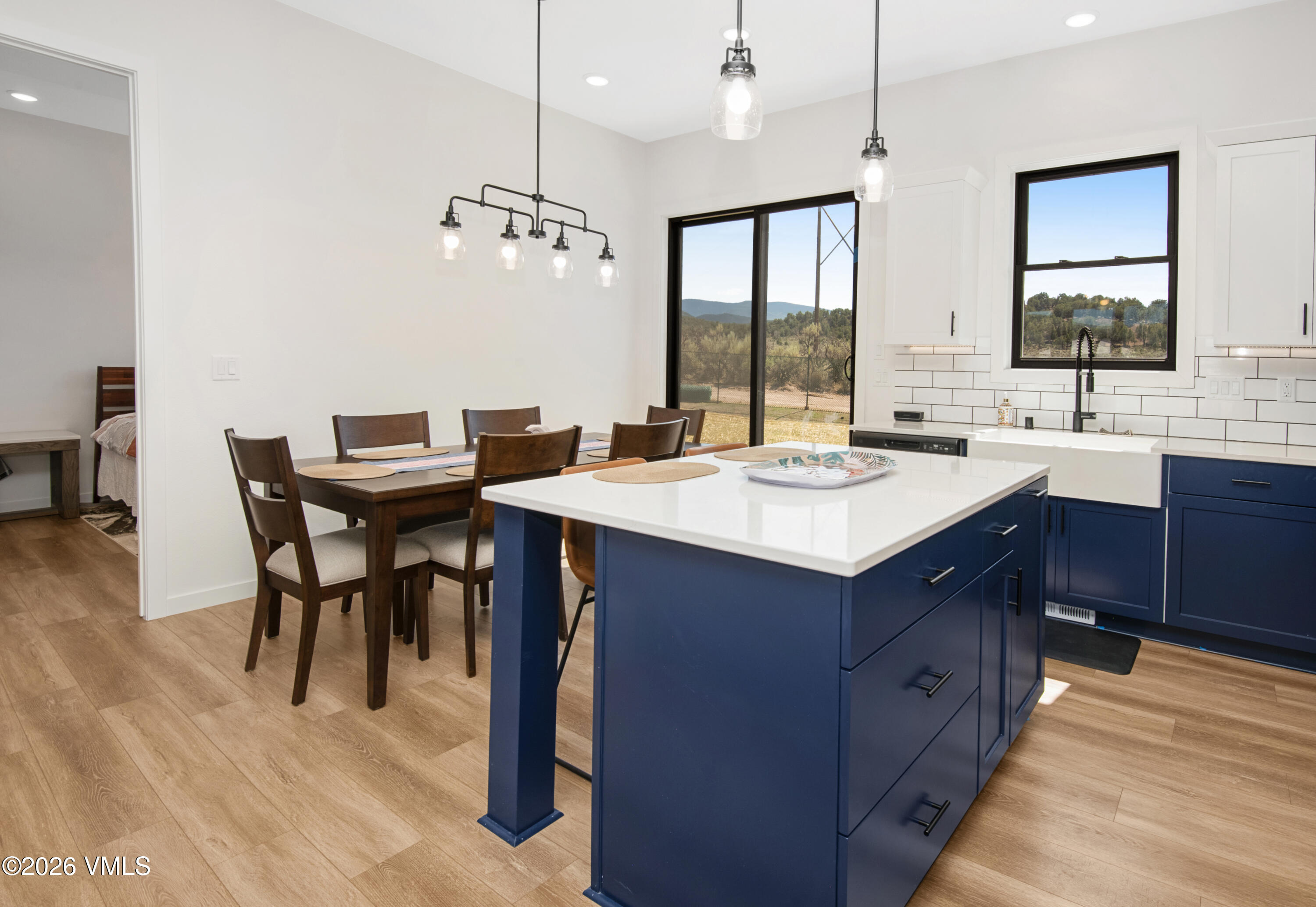 270 Blackhawk Road Gypsum, CO 81637 - Photo 9 of 27 a kitchen with a stove a sink a dining table and chairs