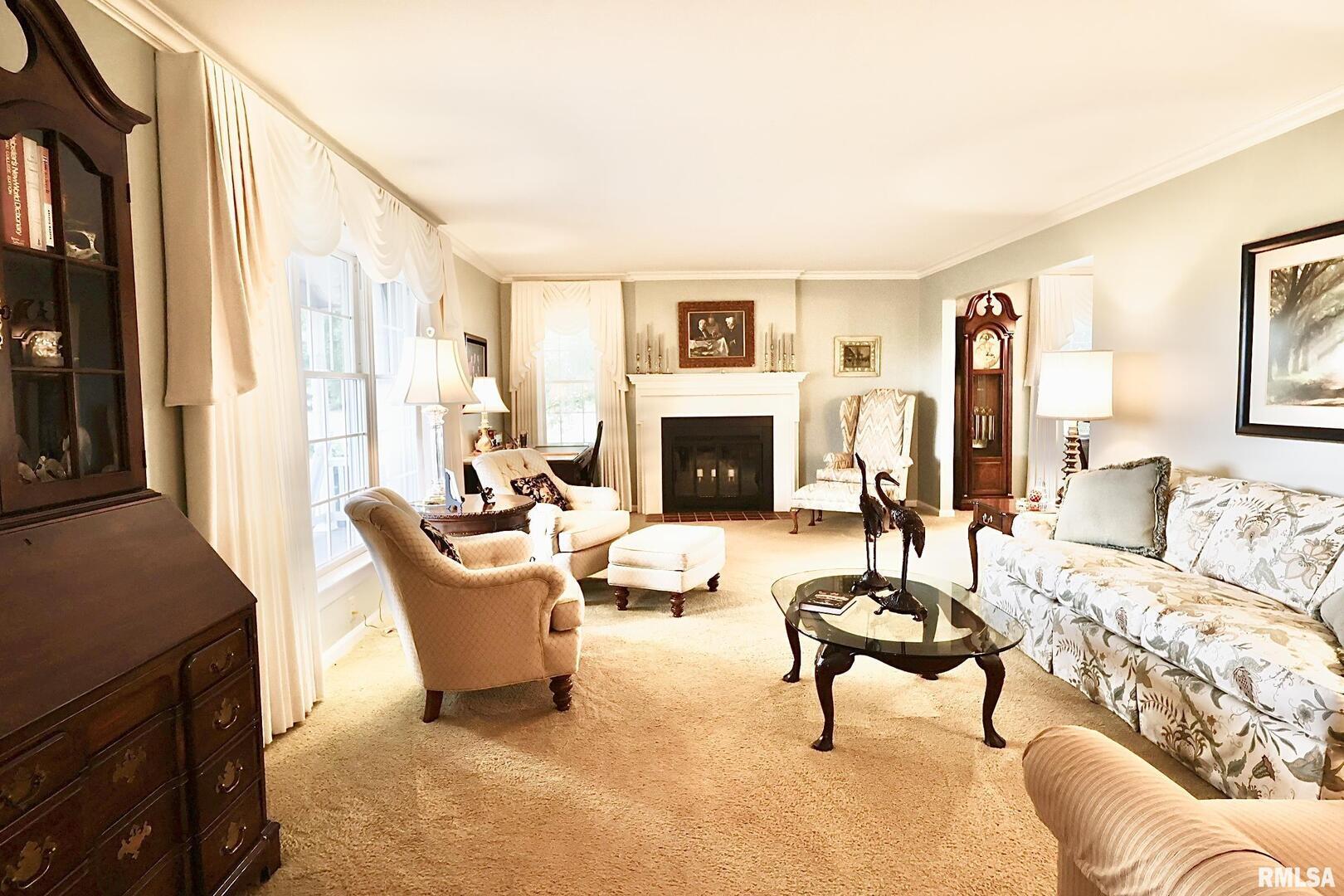 9879 Steel City Road Benton, IL 62812 - Photo 19 of 60 a living room with furniture a fireplace and a large window