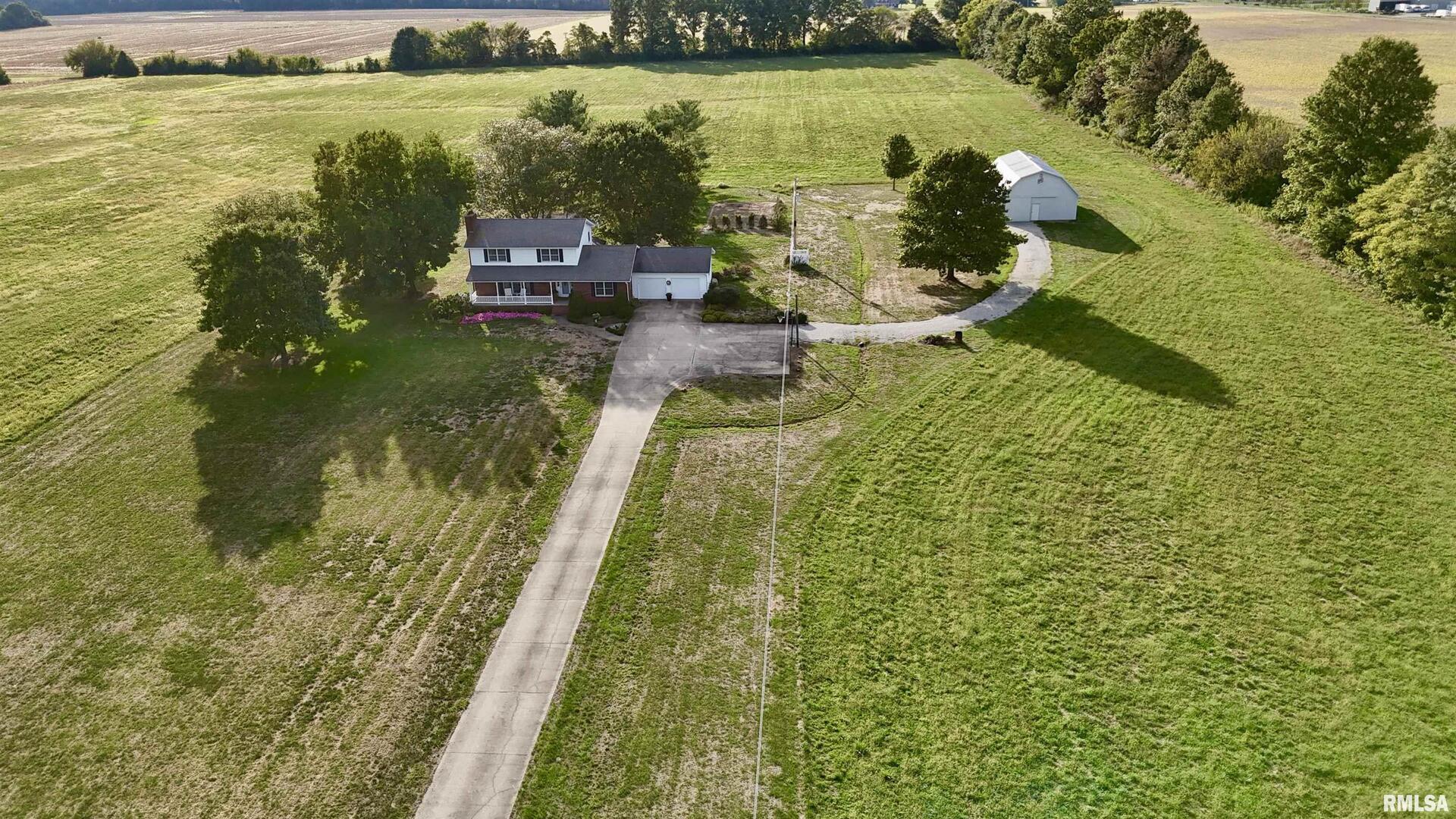 9879 Steel City Road Benton, IL 62812 - Photo 2 of 60 a view of a lake with a house in the background
