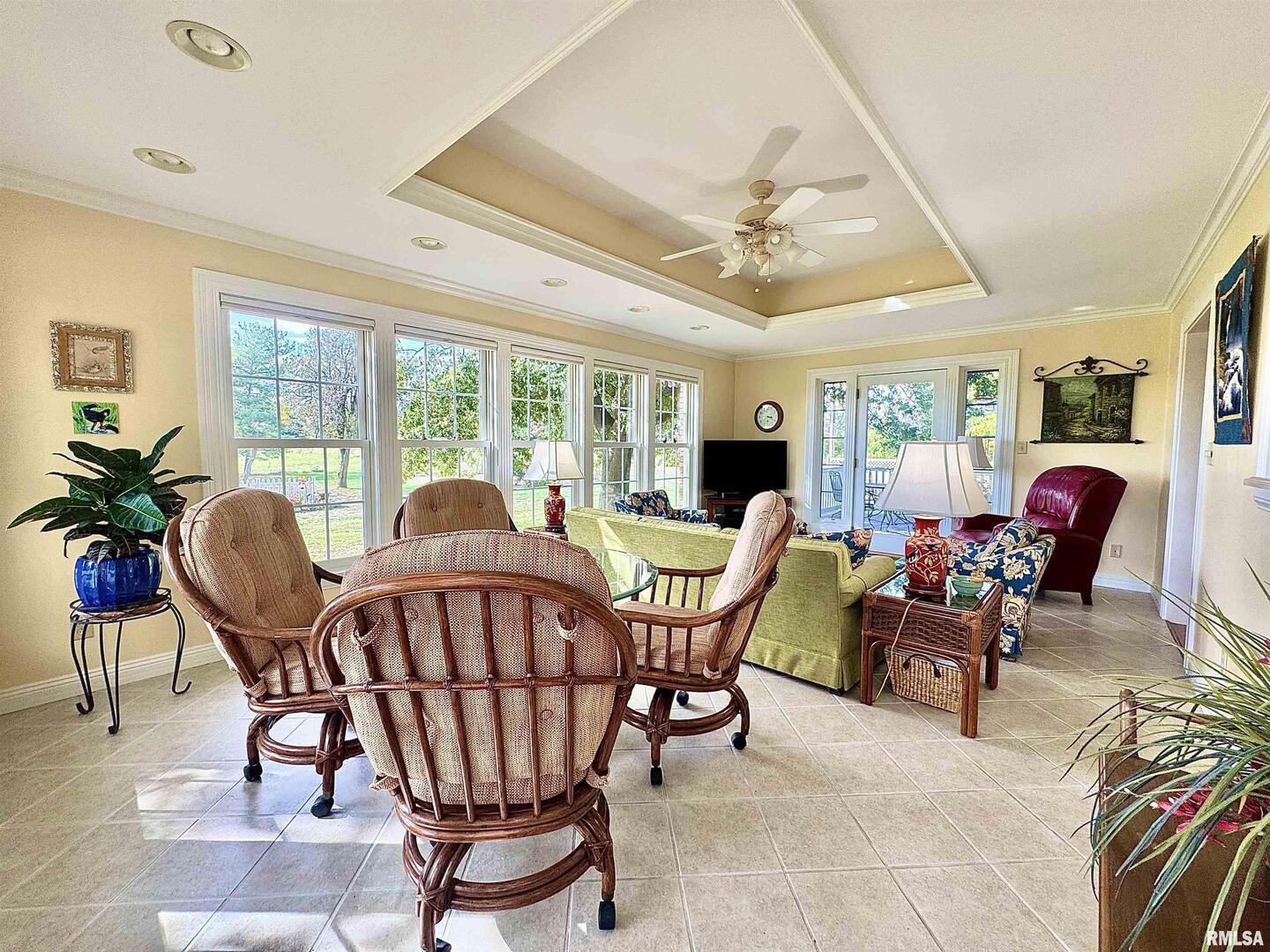 9879 Steel City Road Benton, IL 62812 - Photo 26 of 60 a living room with furniture a dining table and a floor to ceiling window