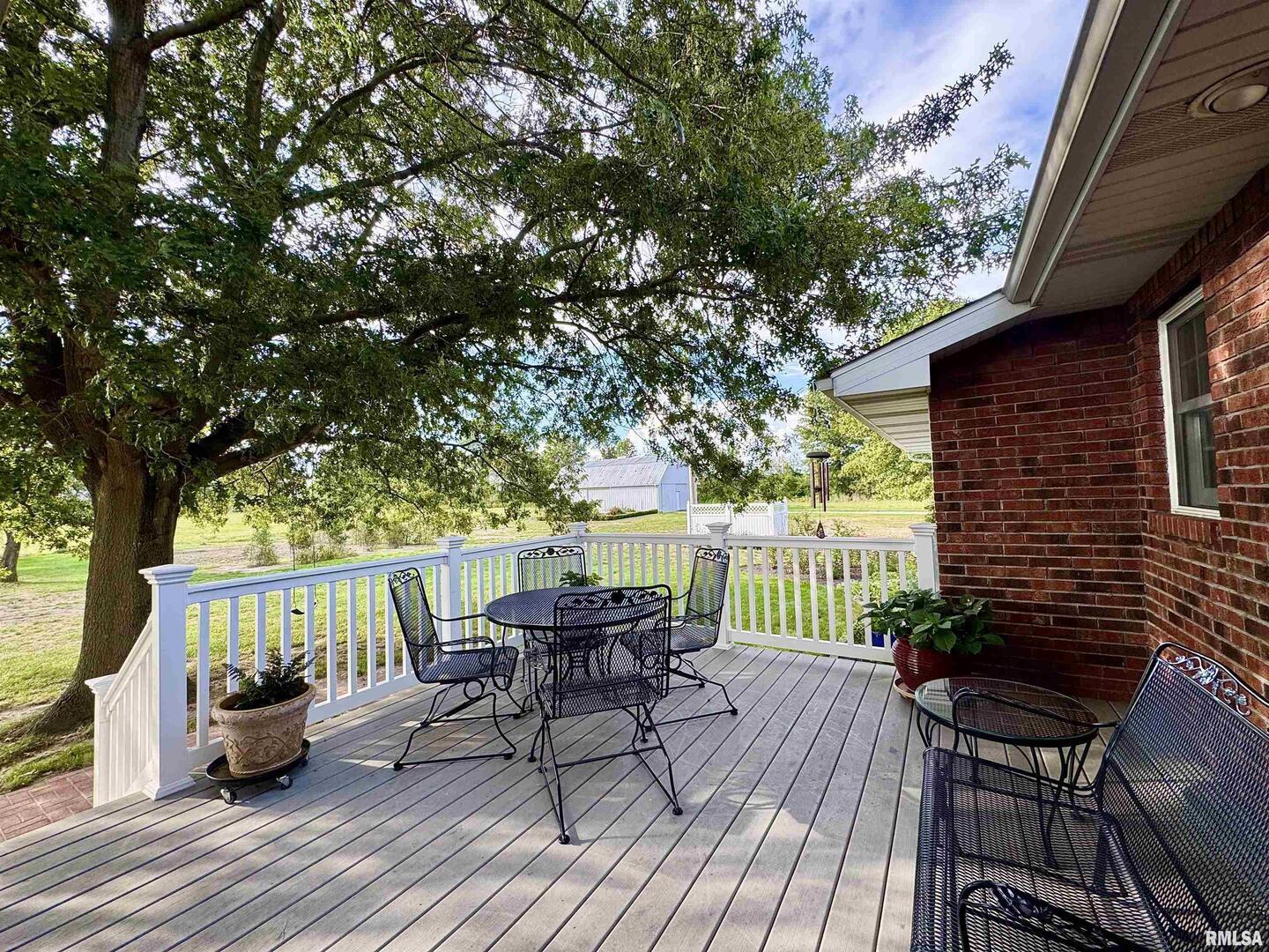 9879 Steel City Road Benton, IL 62812 - Photo 27 of 60 a view of a patio with table and chairs and wooden floor