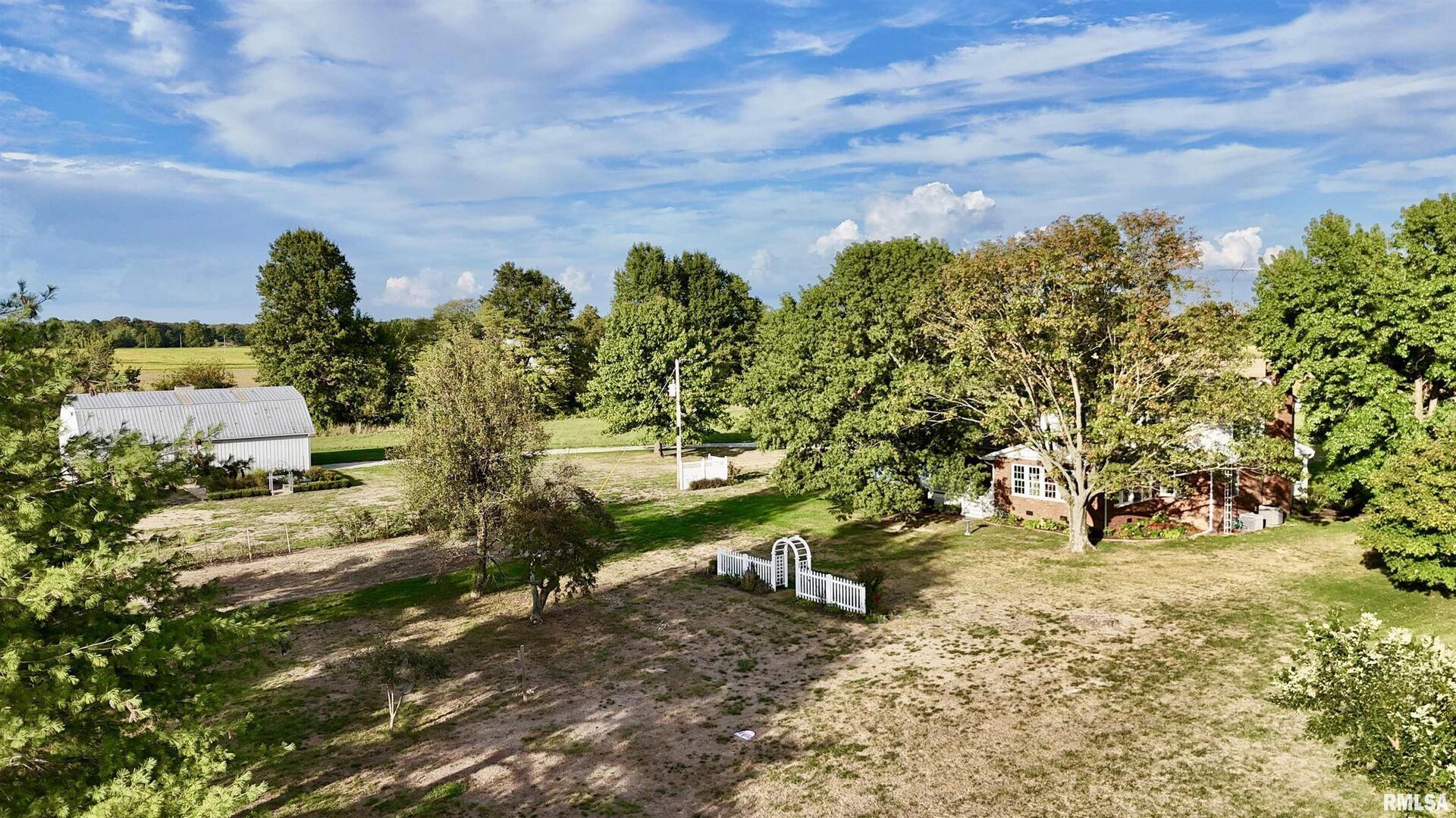 9879 Steel City Road Benton, IL 62812 - Photo 55 of 60 a view of a yard with plants and a bench