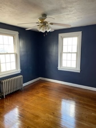 68 Fresno Street Springfield, MA 01104 - Photo 12 of 20 a view of an empty room with wooden floor and a window