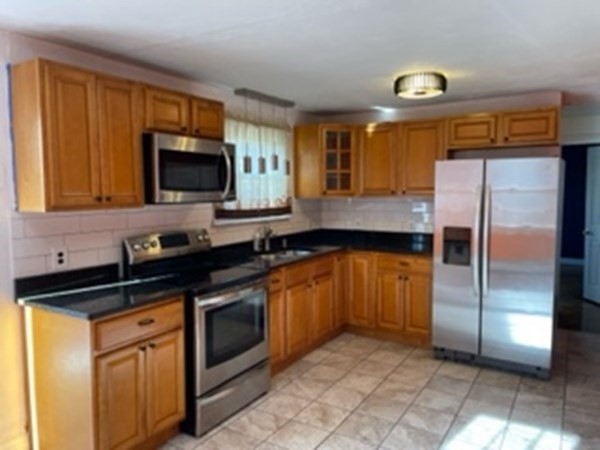 68 Fresno Street Springfield, MA 01104 - Photo 4 of 20 a kitchen with a refrigerator sink and microwave