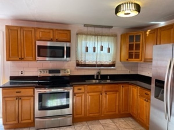 68 Fresno Street Springfield, MA 01104 - Photo 5 of 20 a kitchen with granite countertop stainless steel appliances a stove and a microwave