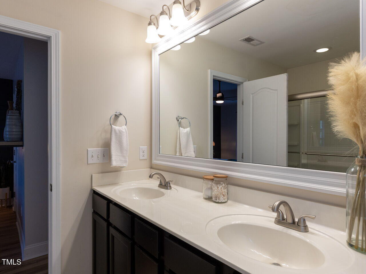 1117 Ileagnes Road Raleigh, NC 27603 - Photo 15 of 27 a bathroom with a double vanity sink and a mirror