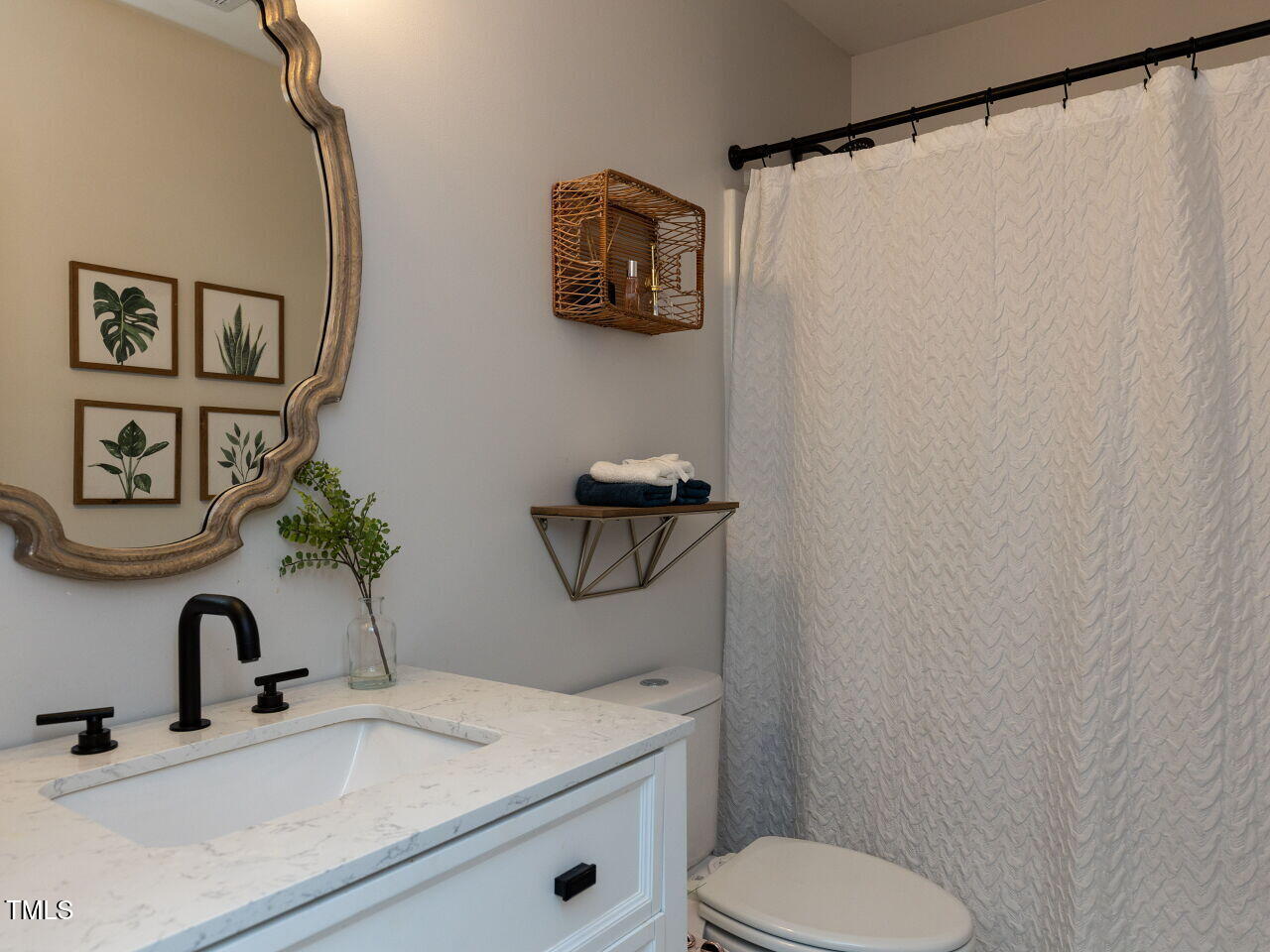 1117 Ileagnes Road Raleigh, NC 27603 - Photo 19 of 27 a bathroom with a sink and a mirror