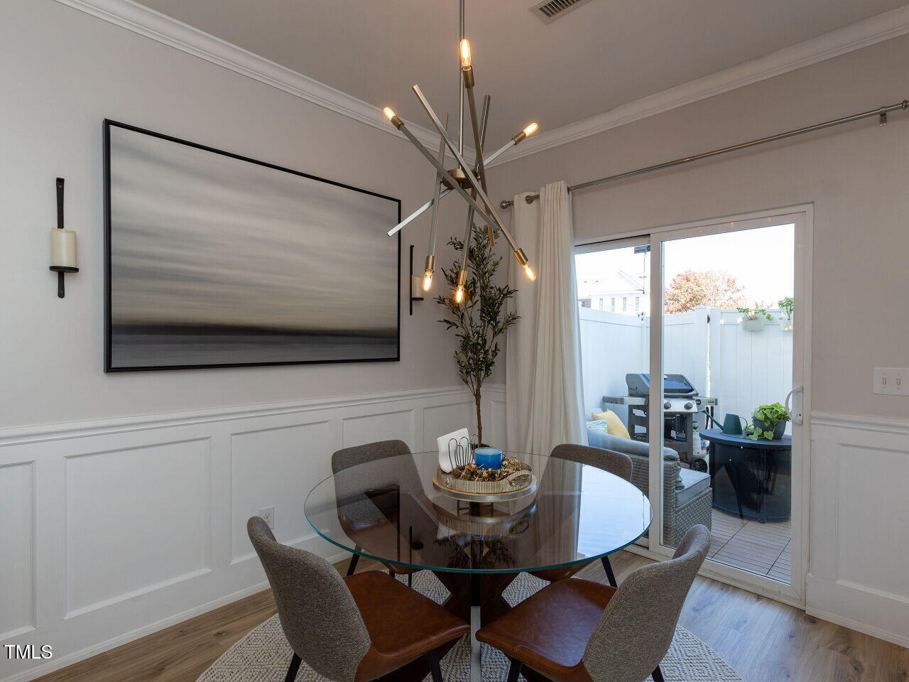 1117 Ileagnes Road Raleigh, NC 27603 - Photo 10 of 27 a dining room with furniture potted plants and wooden floor