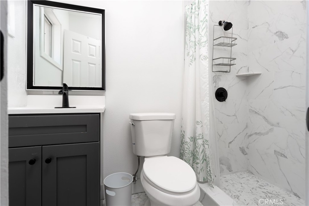 38859 Mesquite Road Palmdale, CA 93551 - Photo 11 of 36 a bathroom with a sink a toilet and shower