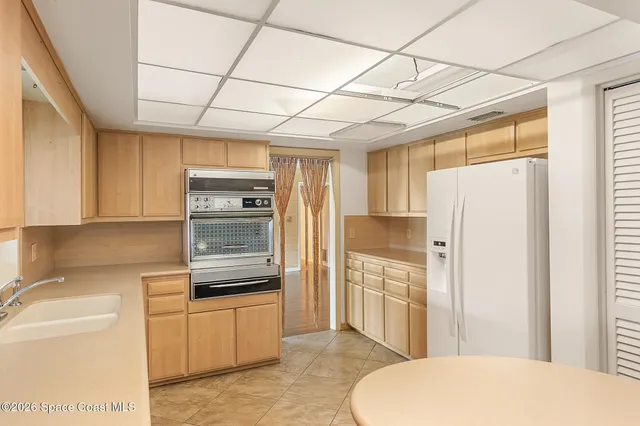 a large white kitchen with a large window