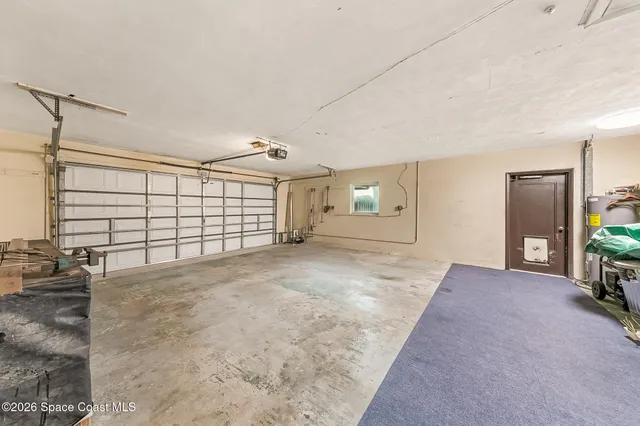 a view of a house with a large window and a yard