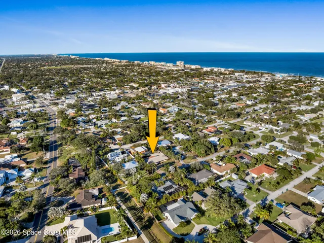 a view of a patio with table and chairs and wooden fence