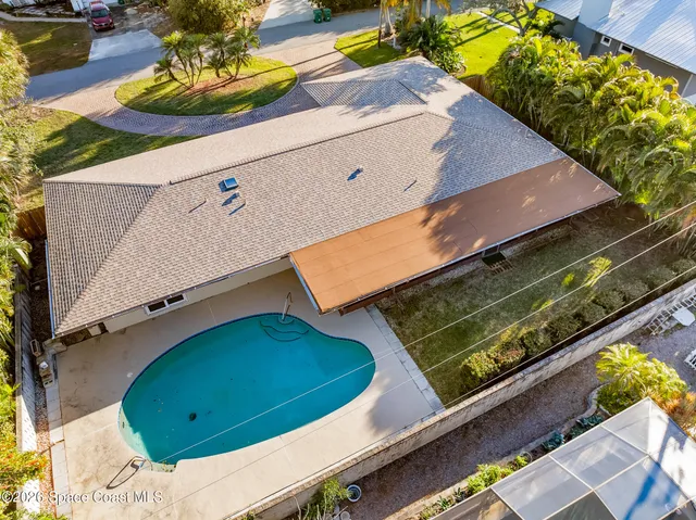 a front view of a house with swimming pool having outdoor seating