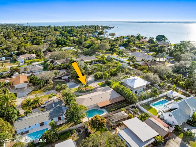a view of a livingroom with wooden floor and a large window