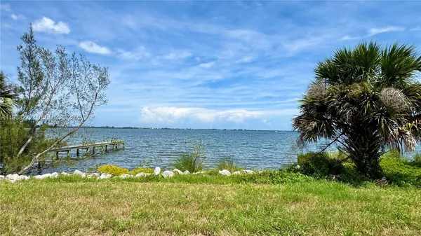 a view of a lake with a yard