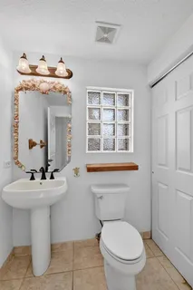 a view of a hallway with wooden floor and windows