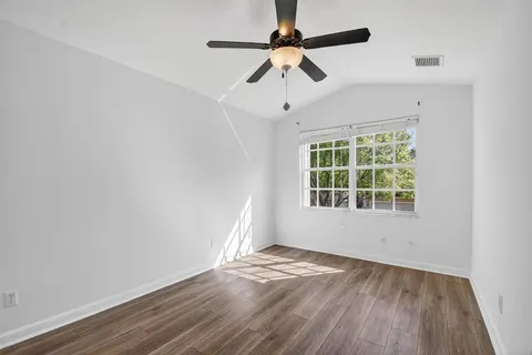 an aerial view of multiple houses with yard