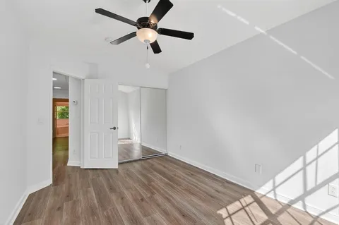 an aerial view of residential houses with outdoor space and trees