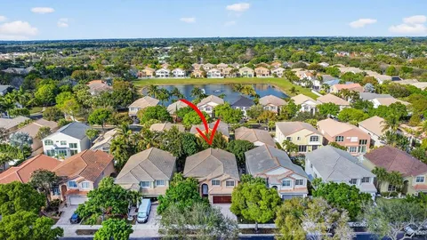 a view of a swimming pool with a patio and a yard