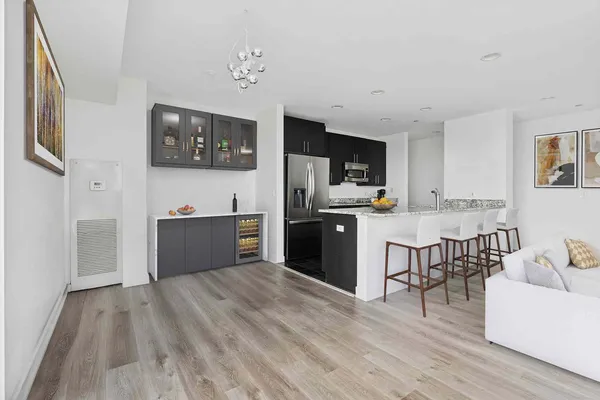a kitchen with stainless steel appliances kitchen island wooden cabinets and granite counter tops
