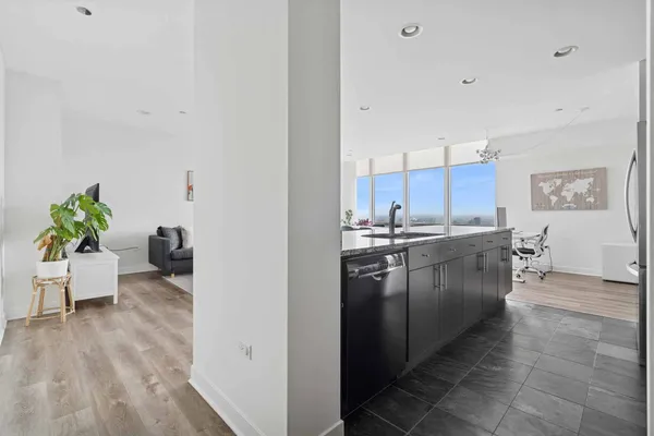 a kitchen with kitchen island granite countertop a sink counter top space and appliances