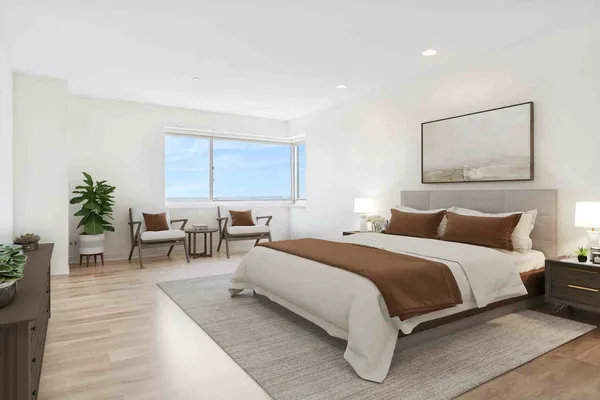 a bedroom with bed and a potted plant