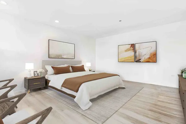 a bedroom with a bed and a painting on the wall