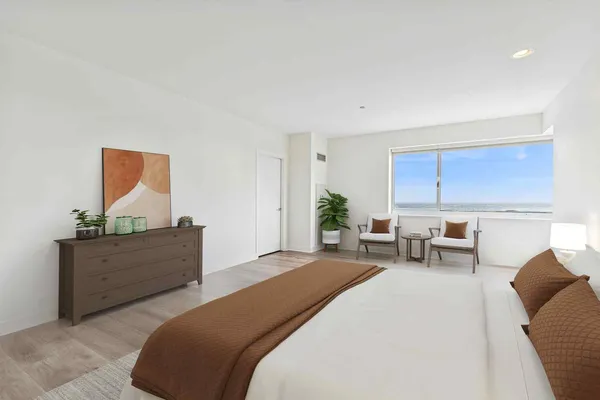 a bedroom with furniture and a window