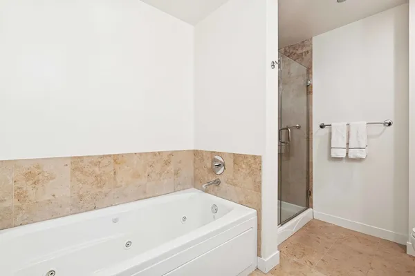 a bathroom with a bathtub and a shower