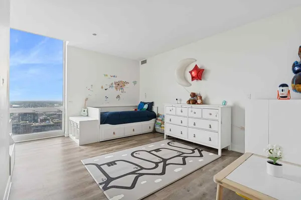 a bedroom with furniture and a dresser