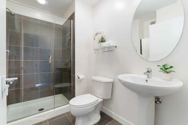 a bathroom with a sink toilet and shower