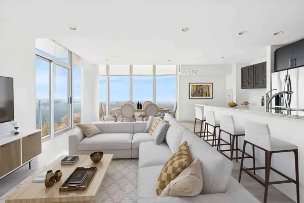 a living room with furniture wooden floor and a flat screen tv