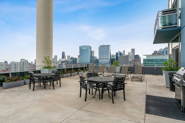 a terrace with outdoor seating and city view