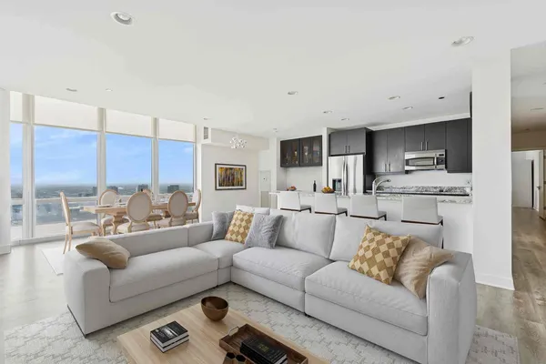 a living room with furniture and kitchen view