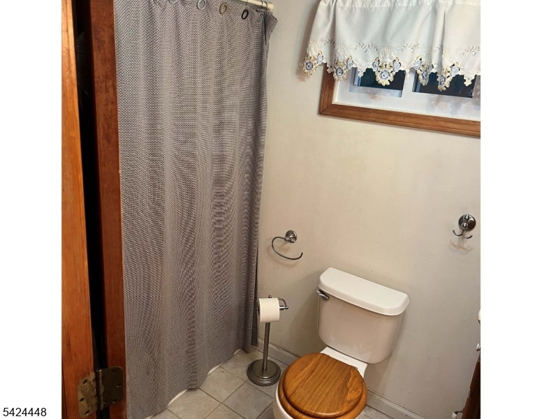 20 Nottingham Drive Howell, NJ 07731 - Photo 8 of 21 a white toilet sitting next to a shower curtain