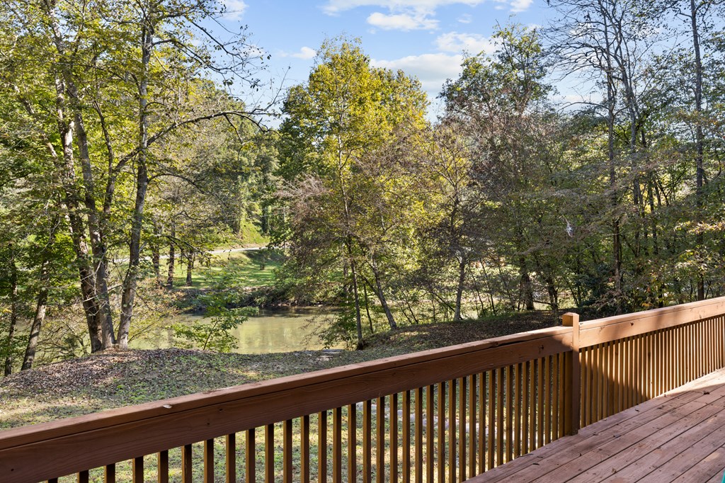 96 Holiday Court Ellijay, GA 30540 - Photo 8 of 51 a view of a wooden balcony and trees