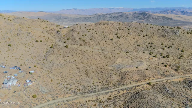 a view of a dry yard with mountains