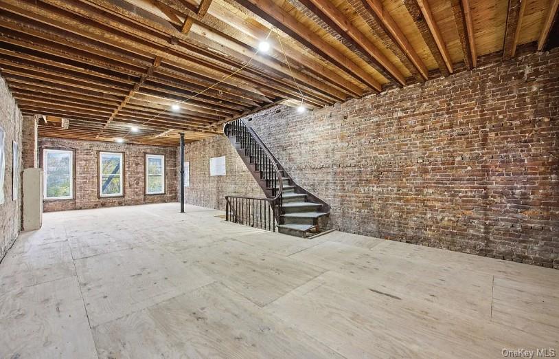 379 7th Street Brooklyn, NY 11215 - Photo 13 of 17 a view of an empty room with stairs and wooden floor