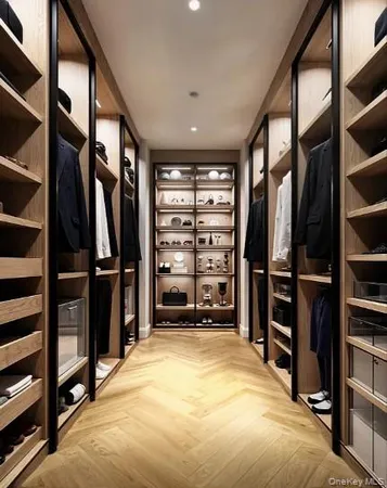 a view of walk in closet with clothes and shoes