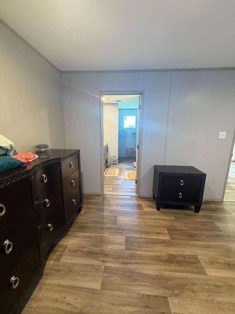 1250 Homestead Avenue Clewiston, FL 33440 - Photo 11 of 32 a spacious bedroom with a bed and a dresser