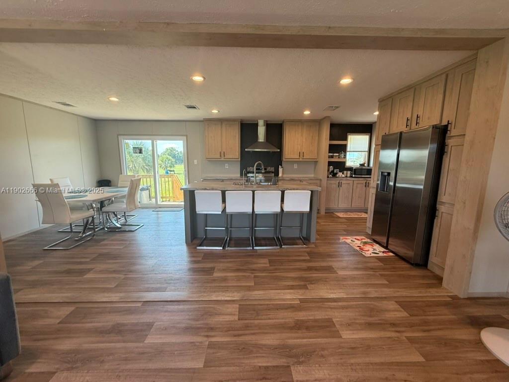 1250 Homestead Avenue Clewiston, FL 33440 - Photo 13 of 32 a living room with fireplace furniture and a wooden floor