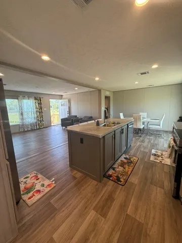 a room with lots of wooden furniture and a wooden floor