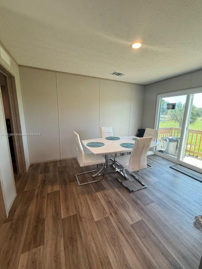 1250 Homestead Avenue Clewiston, FL 33440 - Photo 15 of 32 a living room with a couch wooden floor and a table